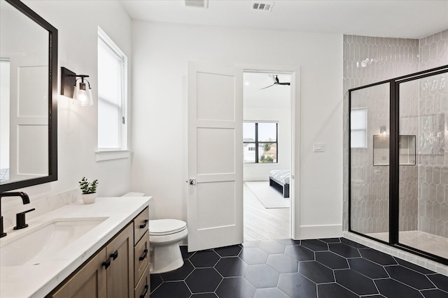 bathroom with a stall shower, tile patterned flooring, vanity, and toilet