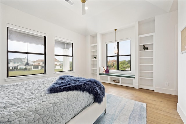 bedroom with wood-type flooring and baseboards