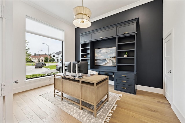 office featuring crown molding, light wood-type flooring, and baseboards
