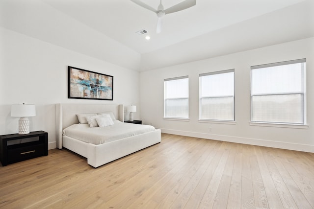 bedroom featuring baseboards, light wood-style flooring, a ceiling fan, and vaulted ceiling
