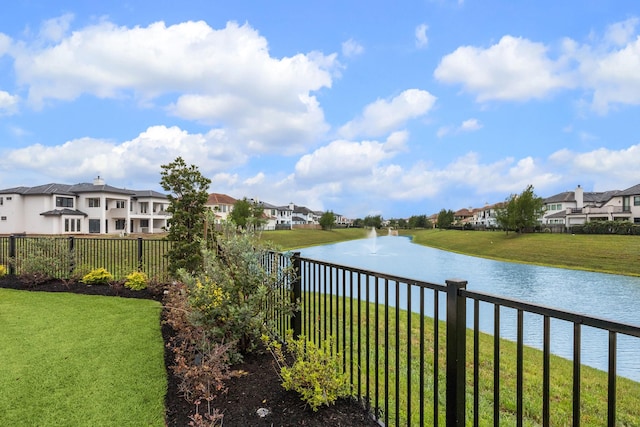 water view featuring nearby suburban area and fence