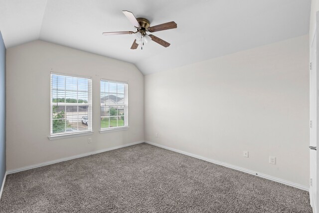 10015 Chase Ct, Baytown, TX 77521 - empty room with vaulted ceiling, ceiling fan, carpet flooring, and baseboards