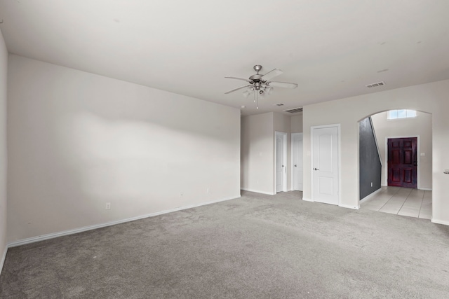 10015 Chase Ct, Baytown, TX 77521 - spare room with arched walkways, light colored carpet, ceiling fan, and baseboards
