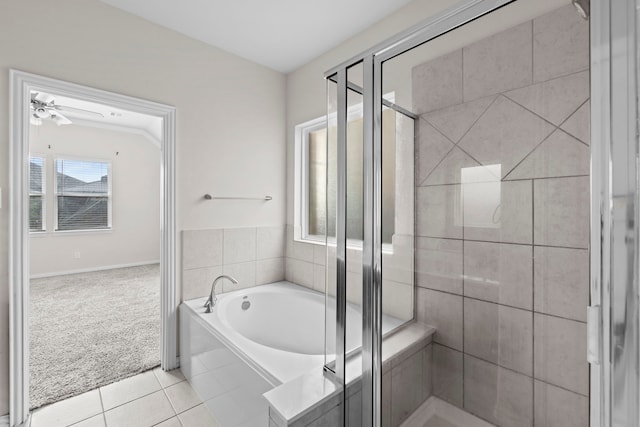10015 Chase Ct, Baytown, TX 77521 - bathroom featuring a shower stall, tile patterned floors, a bath, and baseboards