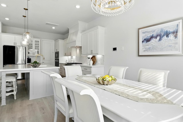 26923 Arethusa Ct, Spring, TX 77389 - dining room featuring light wood-style floors, a chandelier, and recessed lighting