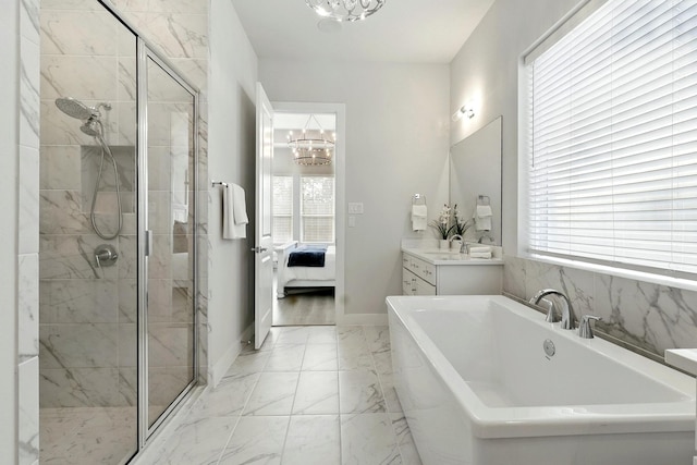 full bath featuring a chandelier, ensuite bath, a shower stall, and marble finish flooring