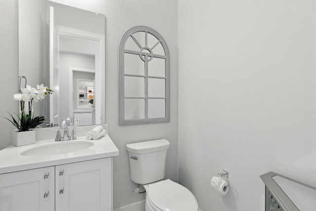 bathroom featuring toilet and vanity