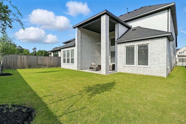 rear view of house with brick siding, a patio, outdoor lounge area, and a shingled roof