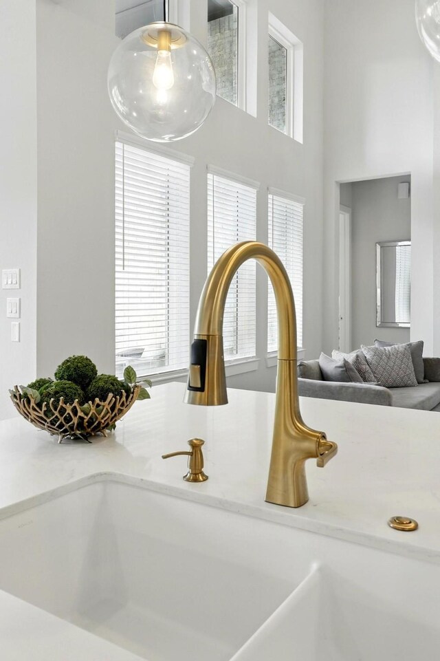 kitchen view of a sink and light countertops