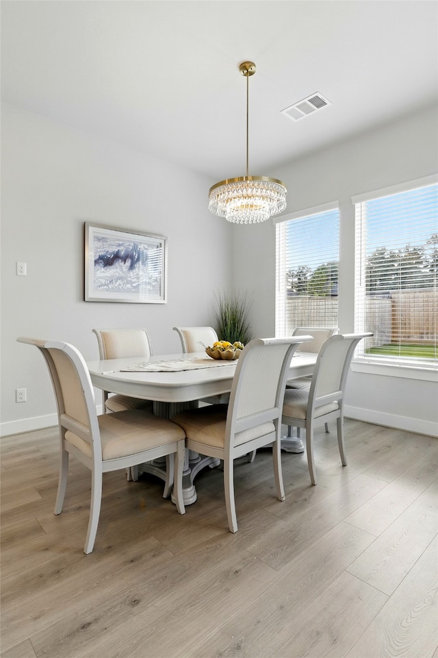 26923 Arethusa Ct, Spring, TX 77389 - dining area featuring a chandelier, baseboards, and light wood-style floors