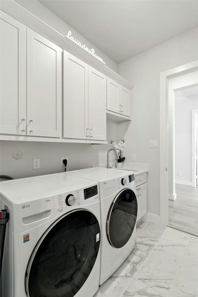 26923 Arethusa Ct, Spring, TX 77389 - laundry area with cabinet space, independent washer and dryer, light marble finish flooring, and baseboards