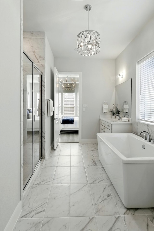 26923 Arethusa Ct, Spring, TX 77389 - ensuite bathroom featuring a chandelier, marble finish flooring, and a freestanding tub