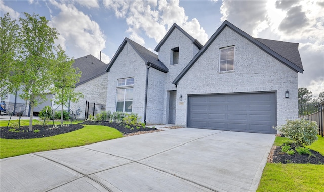26923 Arethusa Ct, Spring, TX 77389 - french provincial home featuring driveway, brick siding, a front lawn, a garage, and a shingled roof