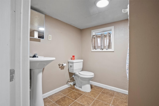 11 Highland Dr, Hitchcock, TX 77563 - half bathroom with toilet, baseboards, and tile patterned floors