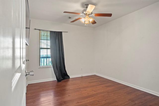 11 Highland Dr, Hitchcock, TX 77563 - spare room with dark wood-type flooring, a ceiling fan, and baseboards