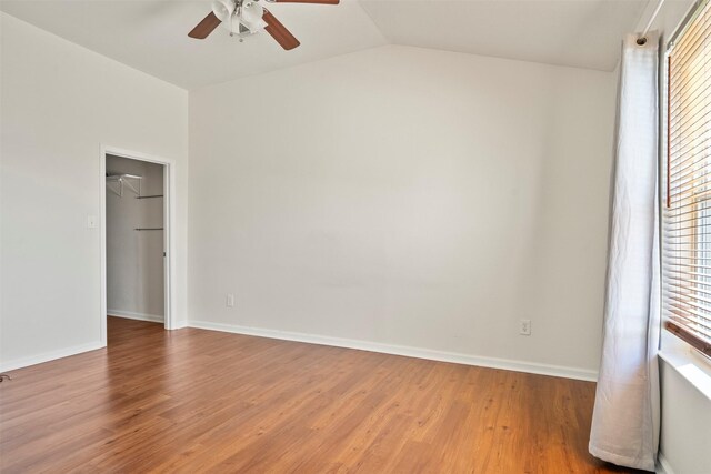 11 Highland Dr, Hitchcock, TX 77563 - empty room with a ceiling fan, plenty of natural light, wood finished floors, baseboards, and lofted ceiling