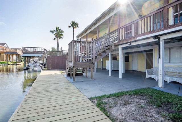 11 Highland Dr, Hitchcock, TX 77563 - dock area featuring stairs, a patio, and a deck with water view