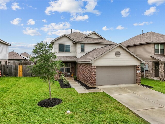 traditional home featuring driveway, an attached garage, brick siding, and a shingled roof