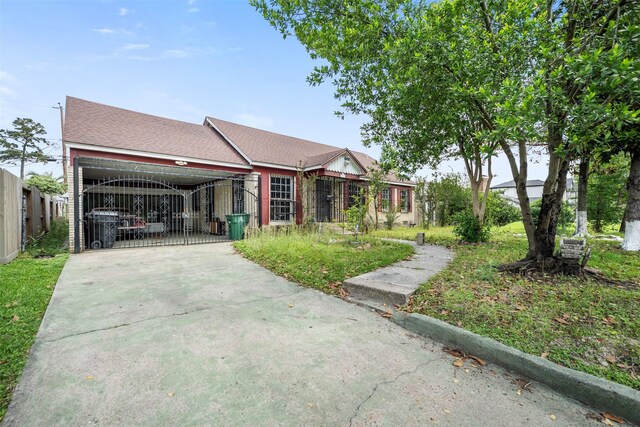view of front of home with concrete driveway, fence, a garage, and a gate