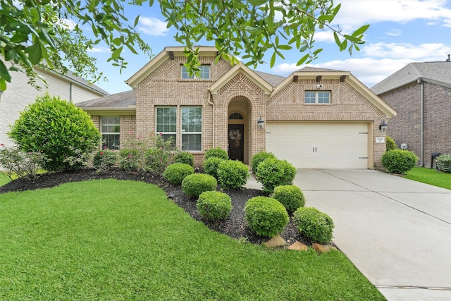 traditional-style house with brick siding, a front yard, concrete driveway, and a garage
