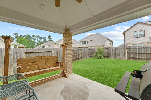 view of yard featuring a patio, a residential view, and a ceiling fan