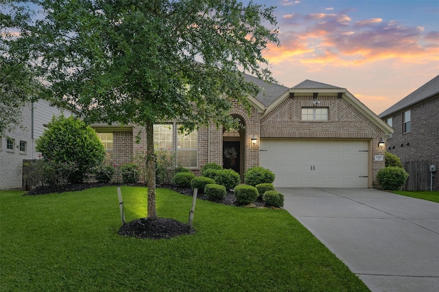 2610 Granite River Ln, Conroe, TX 77385 - view of front of house with brick siding, an attached garage, driveway, and a front yard