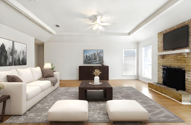 24011 Lone Elm Dr, Spring, TX 77373 - living room with a raised ceiling, ceiling fan, a fireplace, and wood finished floors