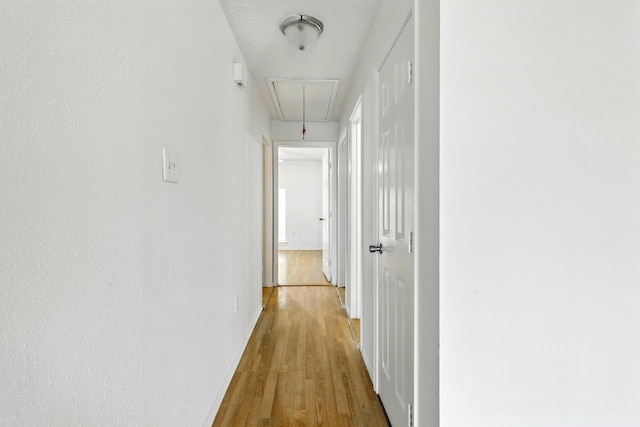 24011 Lone Elm Dr, Spring, TX 77373 - hallway featuring attic access, wood finished floors, and baseboards