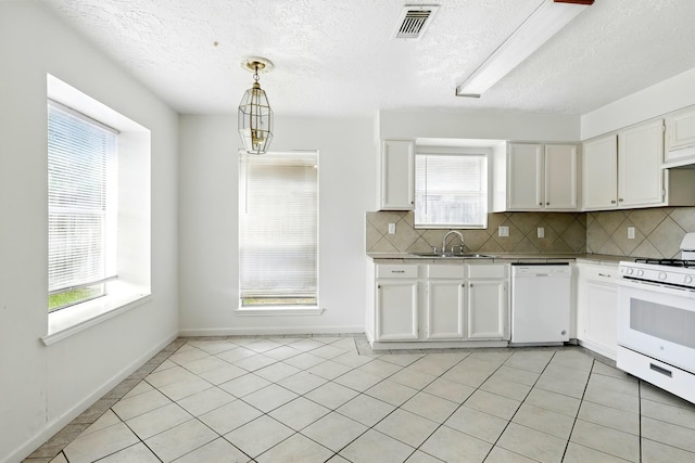 24011 Lone Elm Dr, Spring, TX 77373 - kitchen with white appliances, white cabinetry, tasteful backsplash, a sink, and a textured ceiling