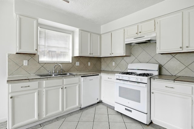 24011 Lone Elm Dr, Spring, TX 77373 - kitchen featuring white appliances, under cabinet range hood, a sink, white cabinets, and a textured ceiling