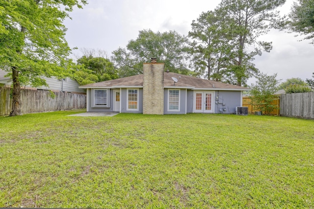 24011 Lone Elm Dr, Spring, TX 77373 - rear view of house featuring french doors, a chimney, and cooling unit