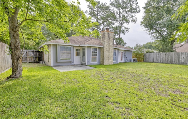 24011 Lone Elm Dr, Spring, TX 77373 - rear view of property featuring a chimney and a patio area