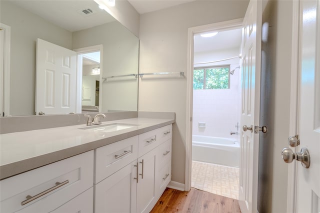 16526 Battlecreek Dr, Houston, TX 77095 - bathroom with vanity, tub / shower combination, wood finished floors, and baseboards