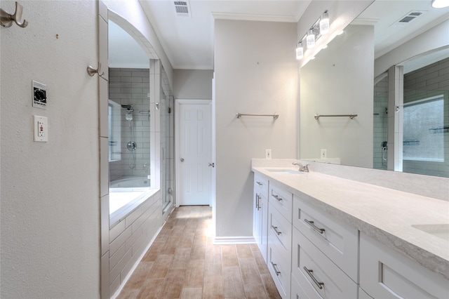 16526 Battlecreek Dr, Houston, TX 77095 - bathroom featuring a tile shower, double vanity, wood finished floors, crown molding, and a bathtub