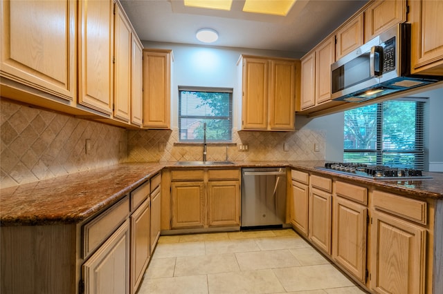 16526 Battlecreek Dr, Houston, TX 77095 - kitchen with appliances with stainless steel finishes, a sink, light tile patterned floors, decorative backsplash, and dark stone counters