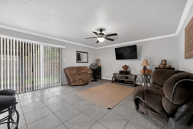 living room featuring healthy amount of natural light, light tile patterned floors, ceiling fan, crown molding, and a textured ceiling