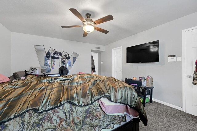 carpeted bedroom with ceiling fan and baseboards