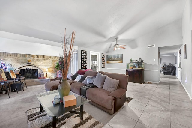 living area with vaulted ceiling, ceiling fan, a fireplace, and baseboards
