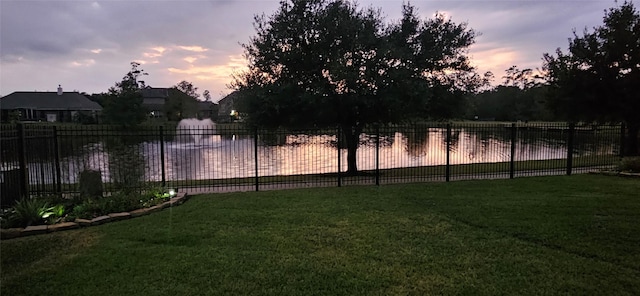 22903 Laburname Ct, Tomball, TX 77375 - yard at dusk with a water view
