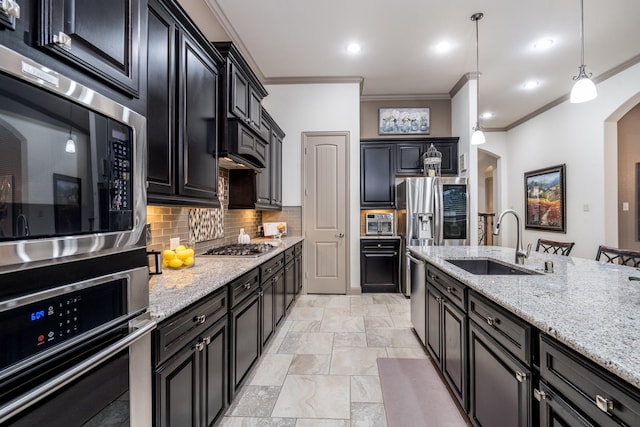22903 Laburname Ct, Tomball, TX 77375 - kitchen featuring stainless steel appliances, a sink, ornamental molding, dark cabinets, and decorative backsplash