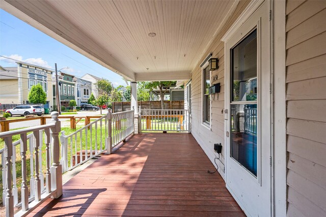 deck featuring covered porch and a residential view