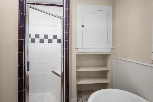 full bathroom featuring a stall shower and a freestanding bath