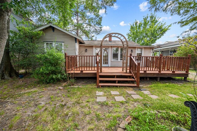 rear view of house featuring a deck