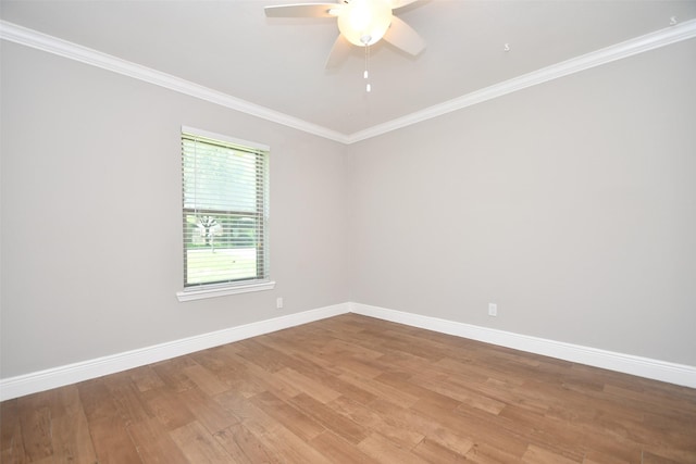 spare room with light wood-style floors, baseboards, ceiling fan, and crown molding