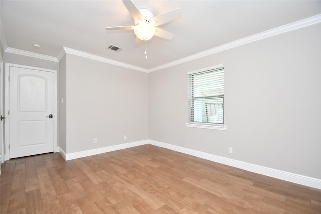 unfurnished room with ceiling fan, ornamental molding, light wood-style flooring, and baseboards