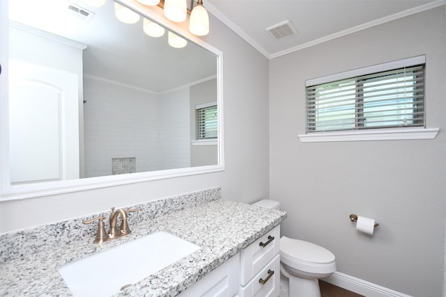 bathroom featuring ornamental molding, vanity, toilet, baseboards, and a shower