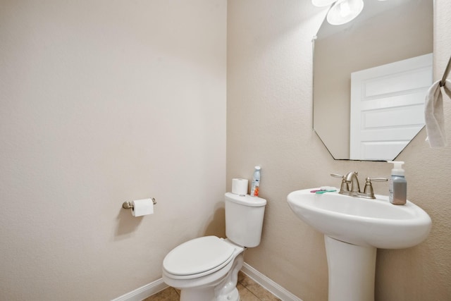 18230 Russett Green Dr, Tomball, TX 77377 - bathroom with toilet, tile patterned flooring, a sink, and baseboards