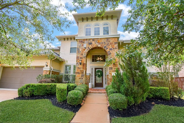 5006 Isidore Ln, Missouri City, TX 77459 - view of front of home with stone siding, stucco siding, driveway, and a garage