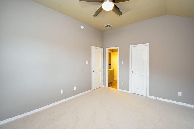 5006 Isidore Ln, Missouri City, TX 77459 - unfurnished bedroom with light carpet, baseboards, lofted ceiling, ensuite bathroom, and a ceiling fan