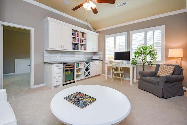 5006 Isidore Ln, Missouri City, TX 77459 - living room with light carpet, wine cooler, a ceiling fan, crown molding, and vaulted ceiling